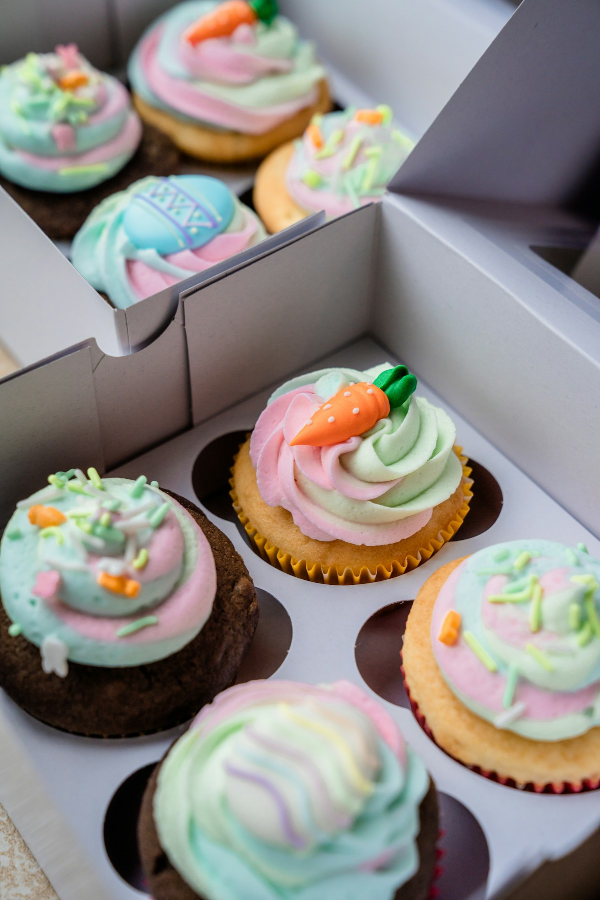 A tray of mini decorated cupcakes