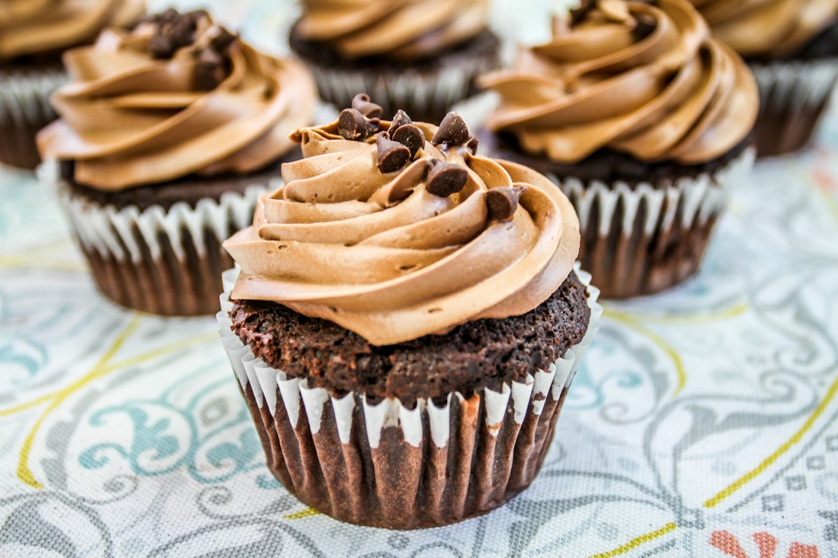 A close-up of a chocolate-frosted cupcake